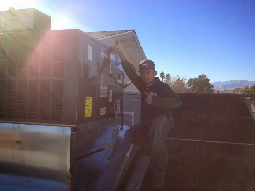 HVAC technician performing AC Tune-Up on a rooftop unit in Villa Hills